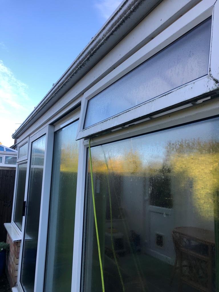 Cleaning conservatory windows with a water-fed pole in Harwich