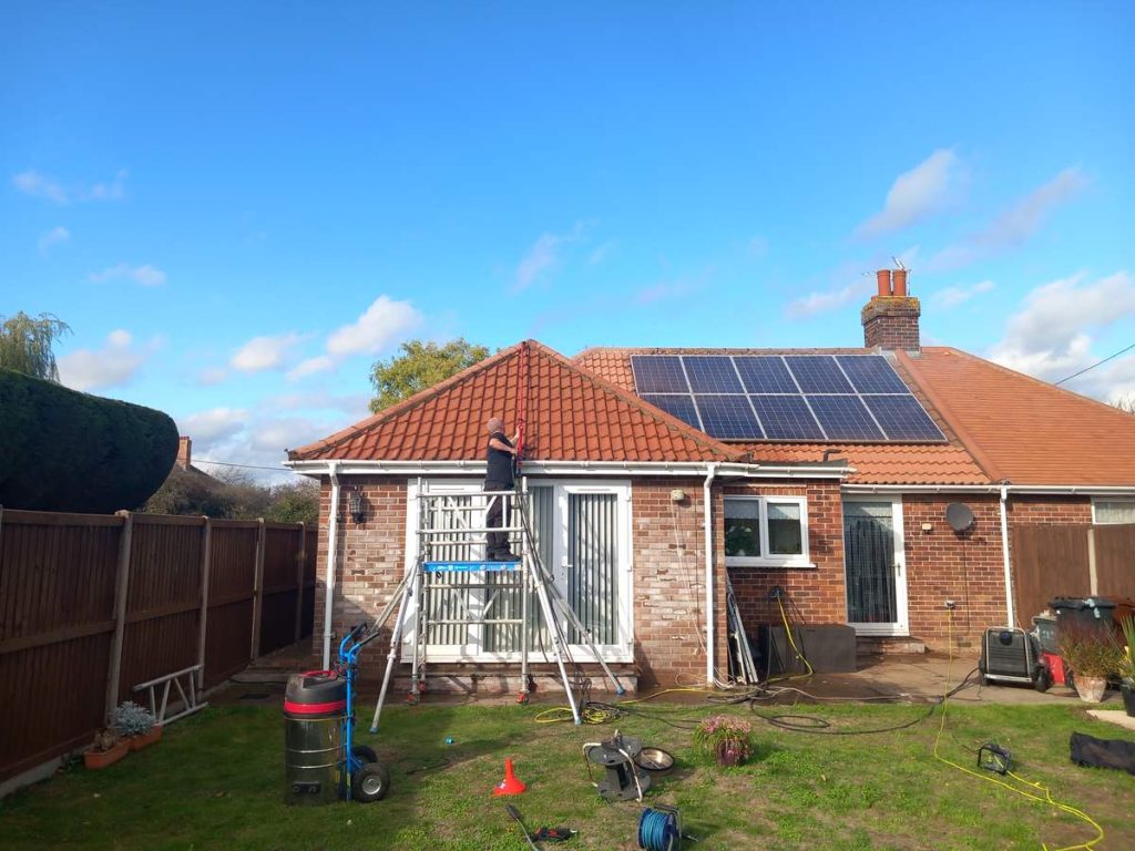 Solar panel cleaning on a bungalow roof by DB Window Cleaning, Holland-on-Sea